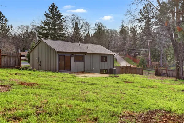 a view of a backyard with large trees