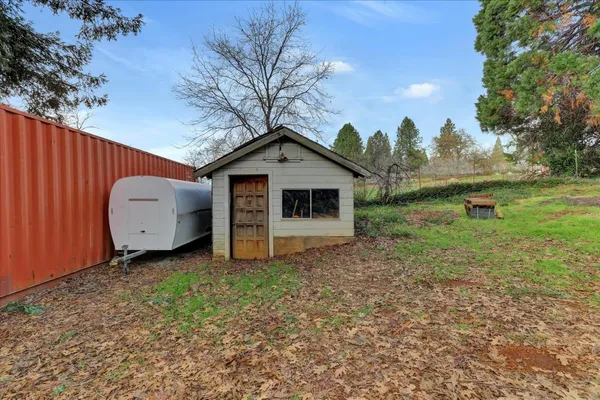 a front view of a house with a yard and trees