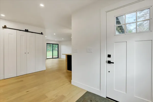 a kitchen with stainless steel appliances kitchen island a refrigerator sink and cabinets