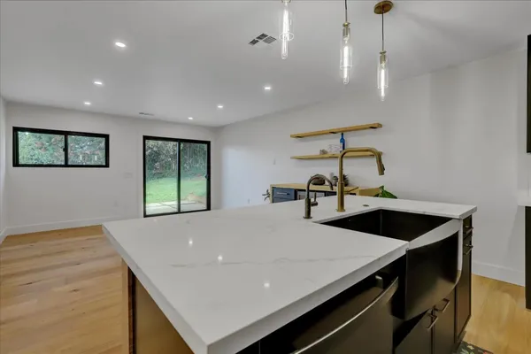 a stove top oven sitting inside of a kitchen