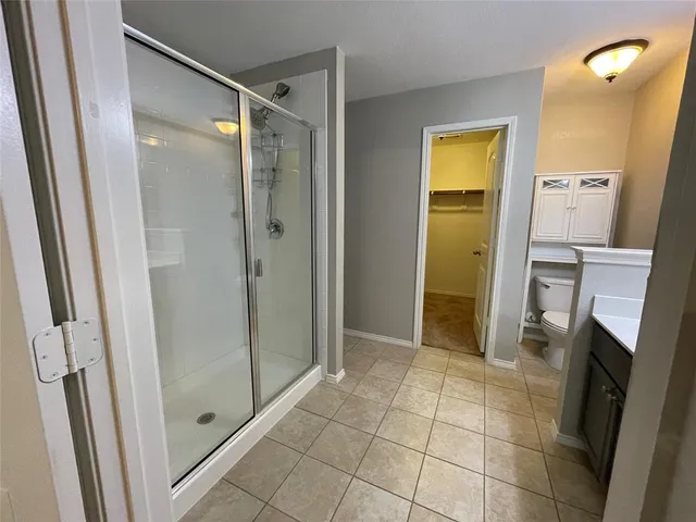 a bathroom with a shower and a sink