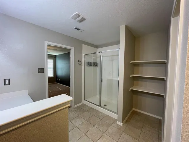 a room that has a bed and a dresser in it