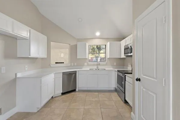 a kitchen with a sink stove and cabinets