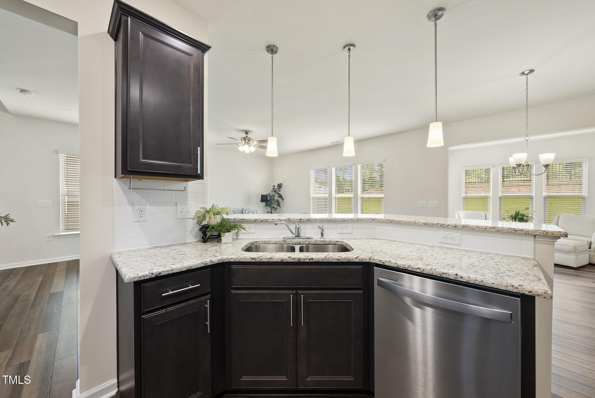 5340 Faulkner Street Durham, NC 27560 - Photo 11 of 31 a kitchen with a sink and a wooden floor