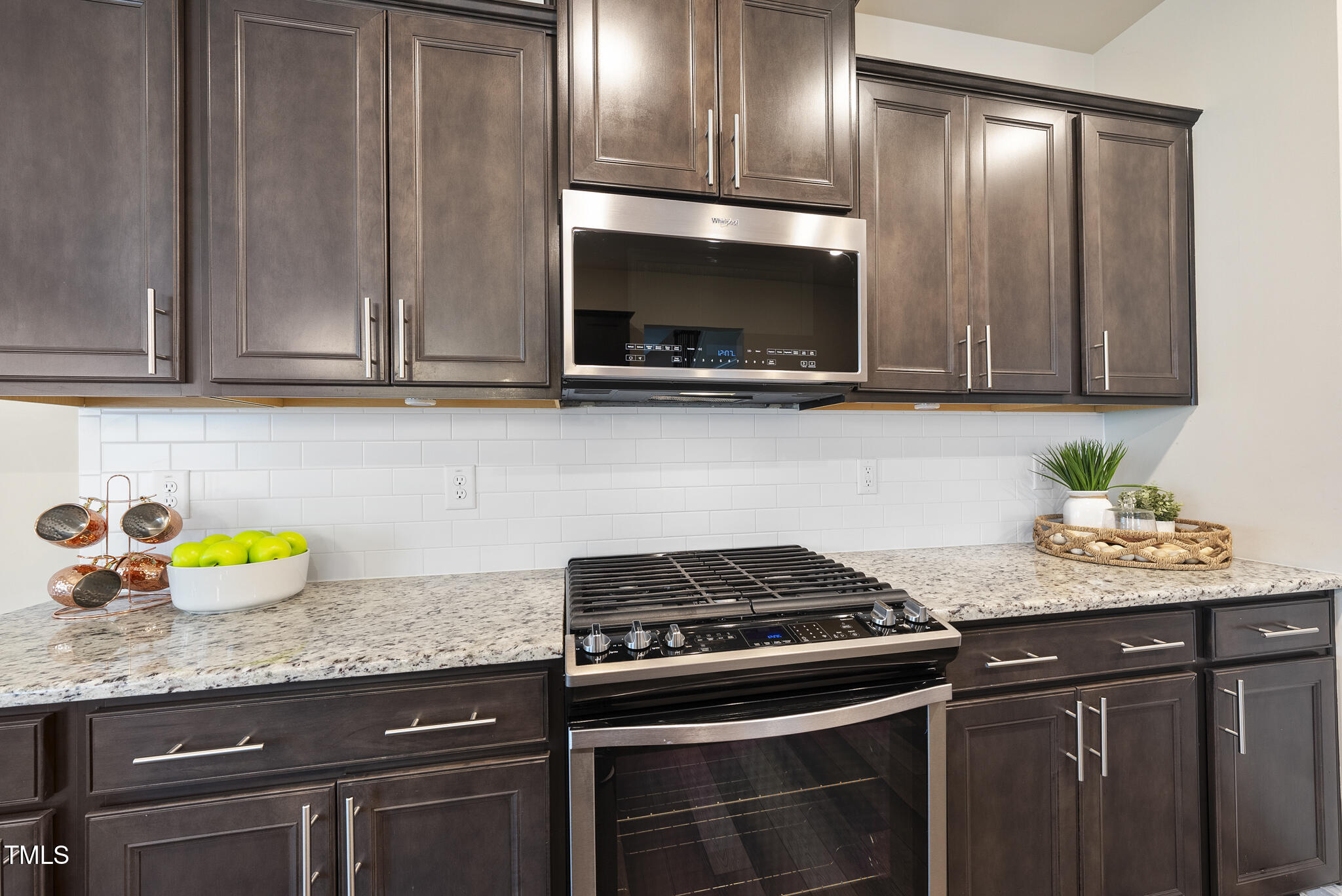 5340 Faulkner Street Durham, NC 27560 - Photo 12 of 31 a kitchen with stainless steel appliances granite countertop a sink stove and cabinets