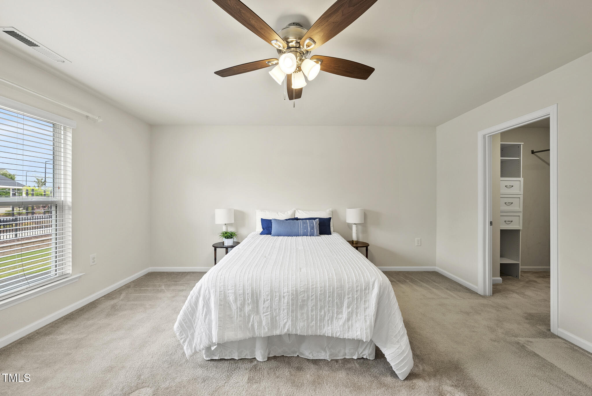 5340 Faulkner Street Durham, NC 27560 - Photo 17 of 31 a bedroom with a bed and a ceiling fan