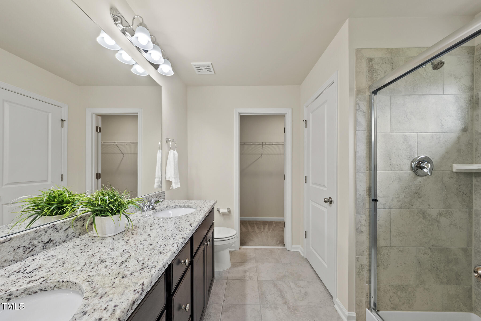 5340 Faulkner Street Durham, NC 27560 - Photo 19 of 31 a bathroom with a granite countertop sink a mirror and a shower