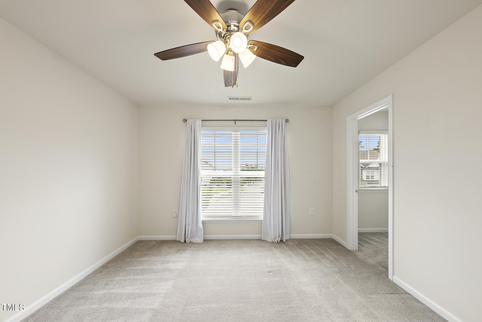 5340 Faulkner Street Durham, NC 27560 - Photo 25 of 31 an empty room with chandelier fan