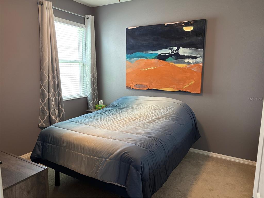 10915 79th Street East Parrish, FL 34219 - Photo 14 of 27 a bedroom with a bed and window