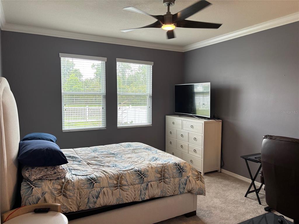 10915 79th Street East Parrish, FL 34219 - Photo 27 of 27 a bedroom with a large bed and a flat tv screen on a dresser