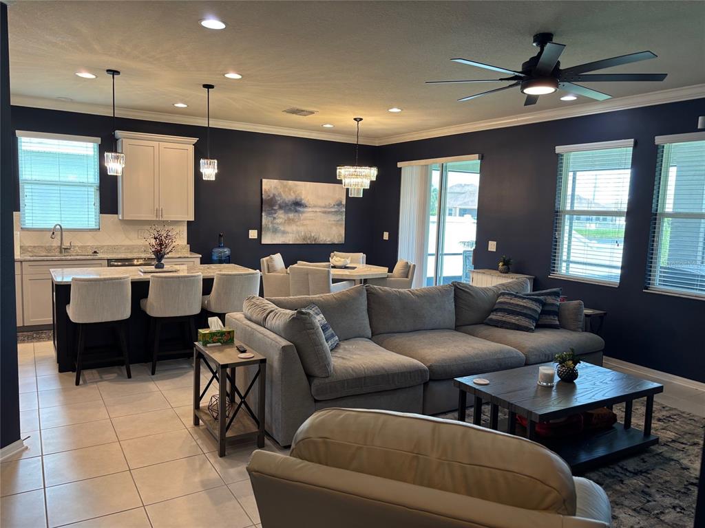 10915 79th Street East Parrish, FL 34219 - Photo 4 of 27 a living room with furniture kitchen view and a large window