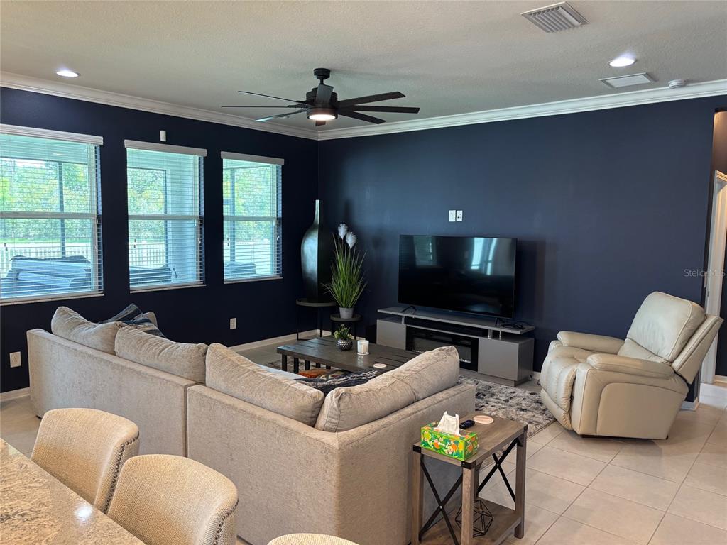 10915 79th Street East Parrish, FL 34219 - Photo 5 of 27 a living room with furniture and a flat screen tv