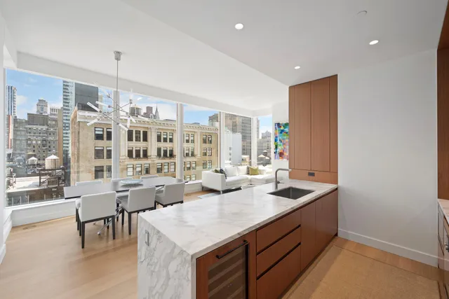 a kitchen with a sink dishwasher a dining table and chairs