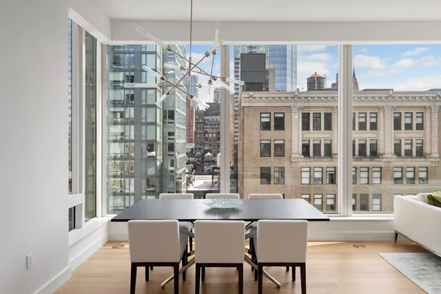 a dining room with a large window table and chairs