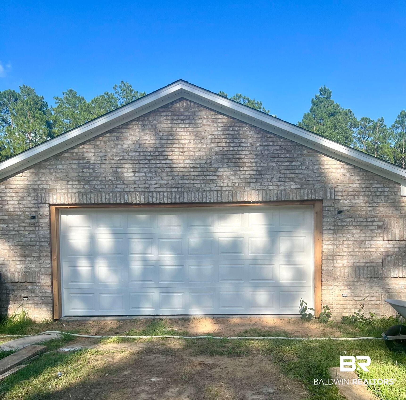 29685 Gardner Road Elberta, AL 36530 - Photo 15 of 16 Brick exterior garage featuring a white panel garage door