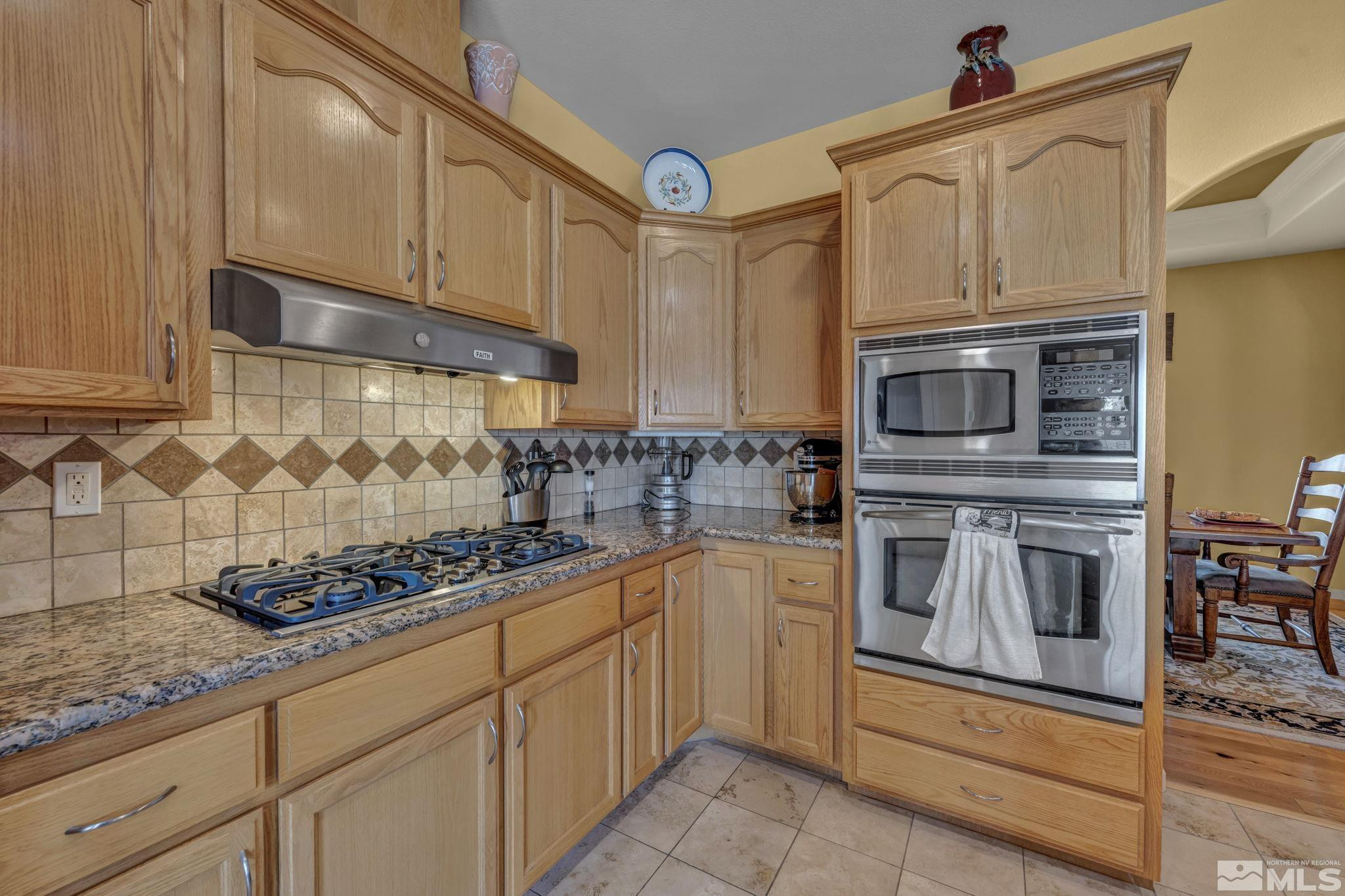 67 Desert View Drive Smith Valley, NV 89430 - Photo 32 of 36 a kitchen with stainless steel appliances granite countertop a stove and a sink
