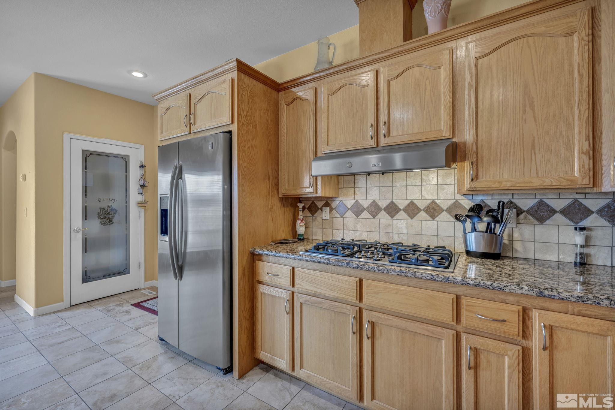 67 Desert View Drive Smith Valley, NV 89430 - Photo 33 of 36 a kitchen with stainless steel appliances granite countertop a refrigerator and a sink