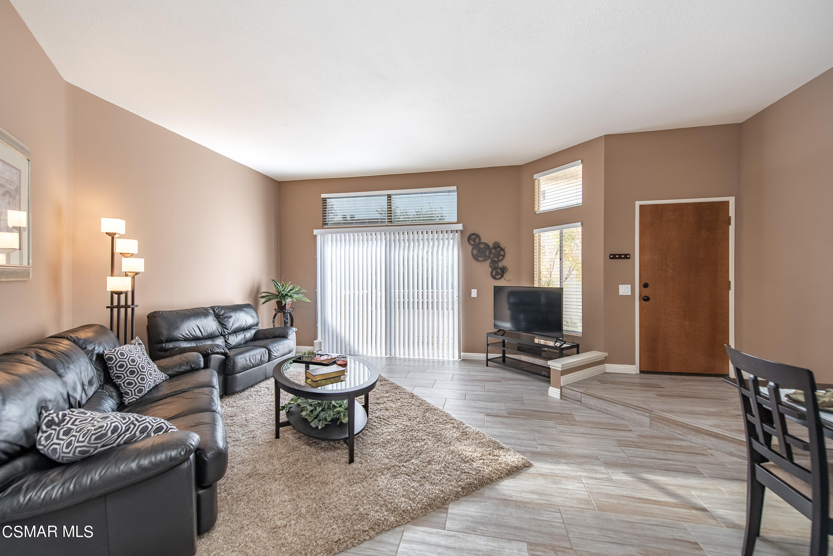 1736 Sinaloa Road, Unit 315 Simi Valley, CA 93065 - Photo 3 of 31 a living room with furniture a wooden floor and a flat screen tv