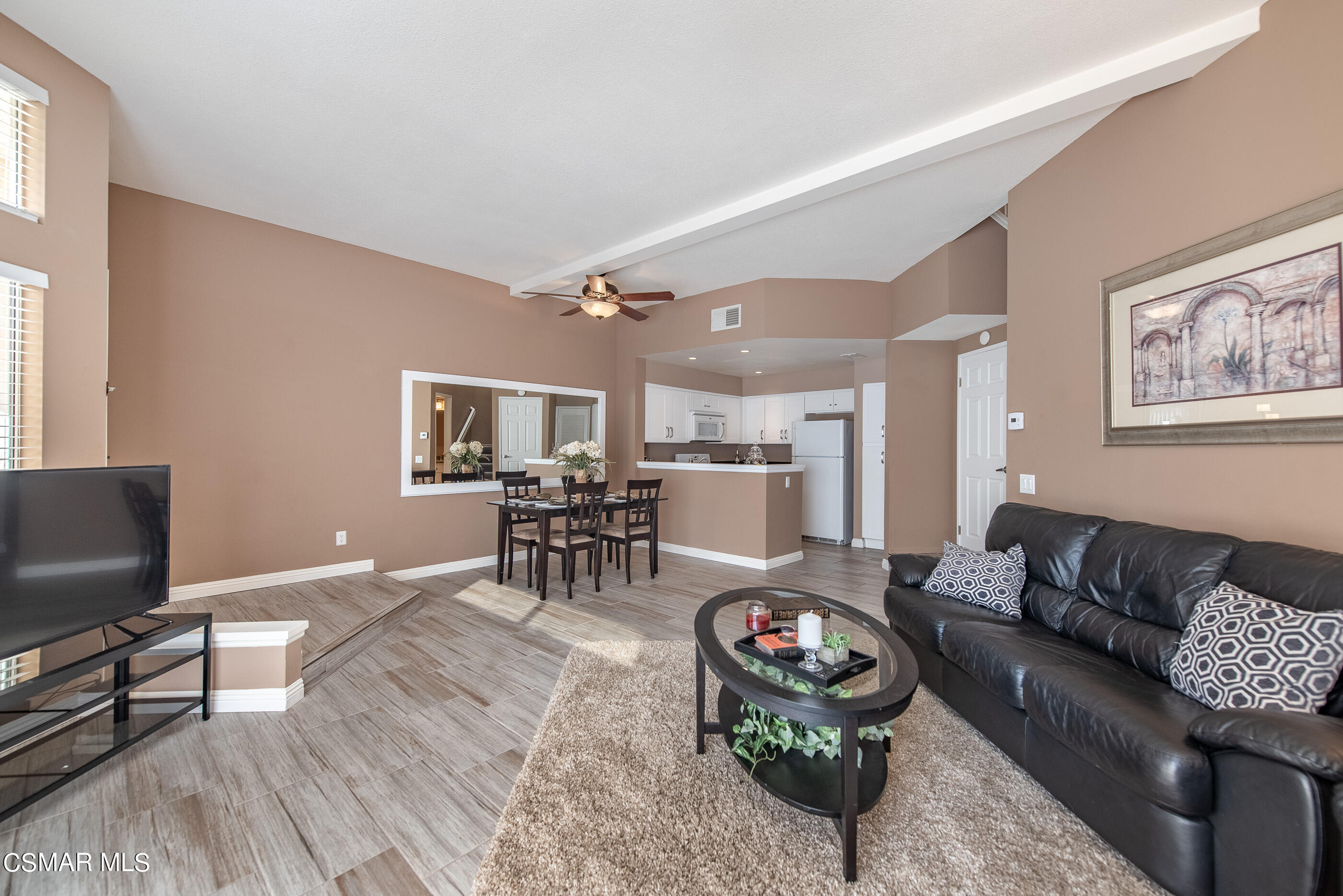 1736 Sinaloa Road, Unit 315 Simi Valley, CA 93065 - Photo 4 of 31 a living room with furniture and a flat screen tv with kitchen view