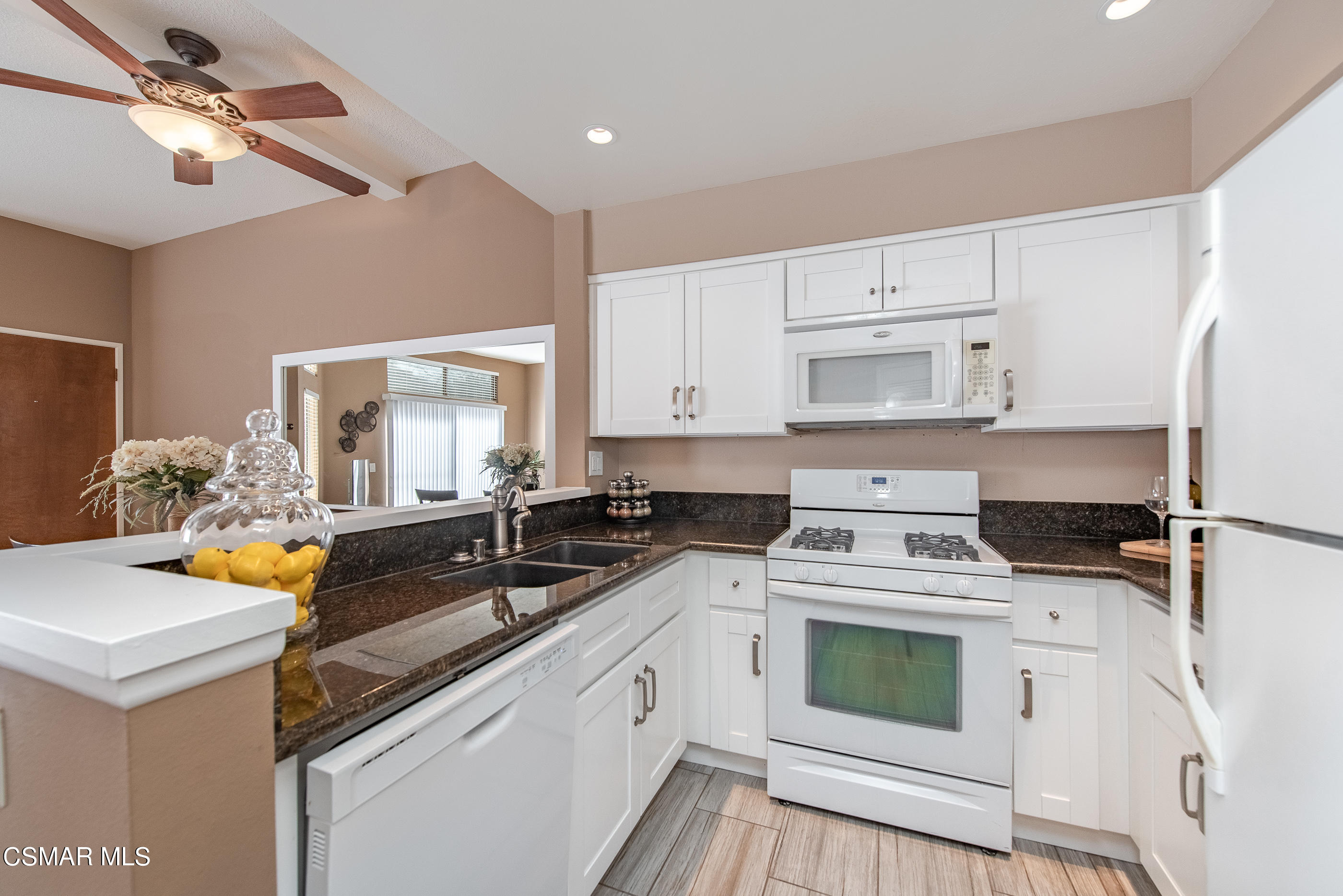 1736 Sinaloa Road, Unit 315 Simi Valley, CA 93065 - Photo 7 of 31 a kitchen with stainless steel appliances granite countertop a sink stove and refrigerator