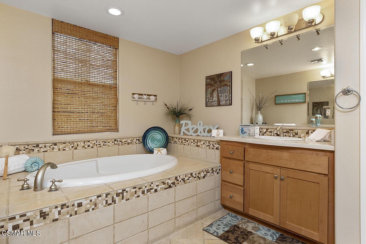 1501 Windshore Way Oxnard, CA 93035 - Photo 15 of 24 a bathroom with a tub sink and mirror