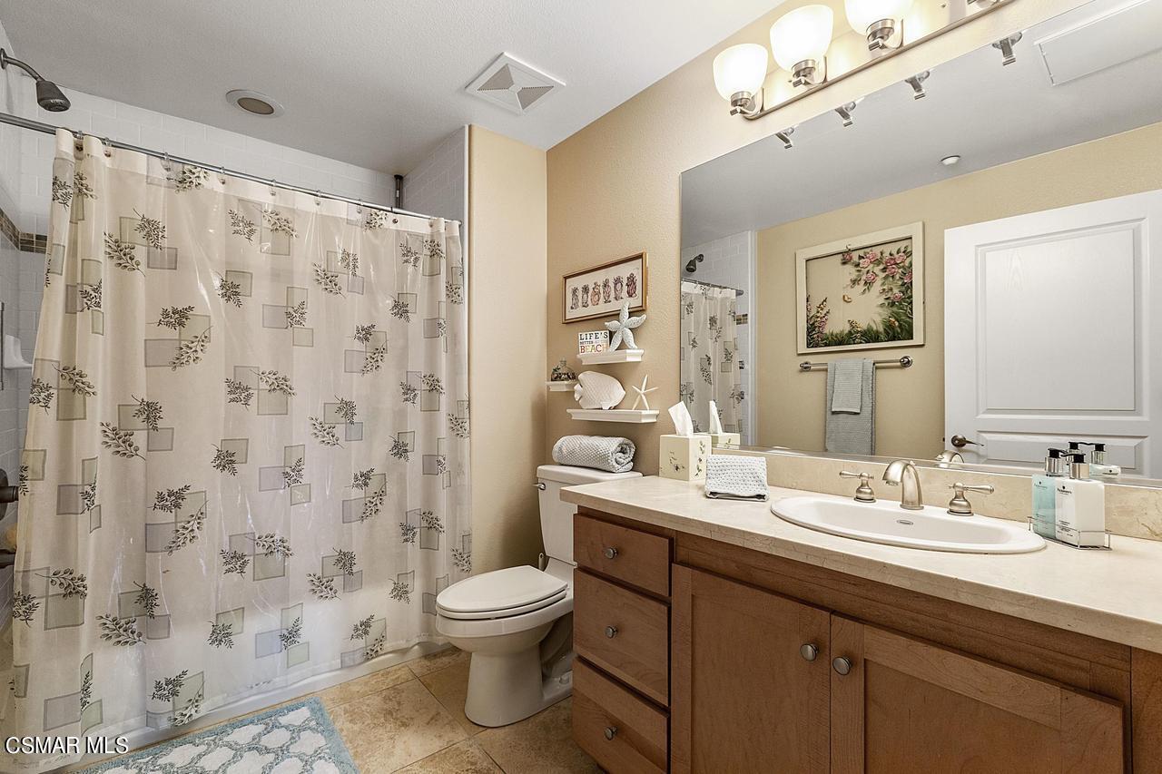1501 Windshore Way Oxnard, CA 93035 - Photo 18 of 24 a bathroom with a sink a toilet and shower curtain