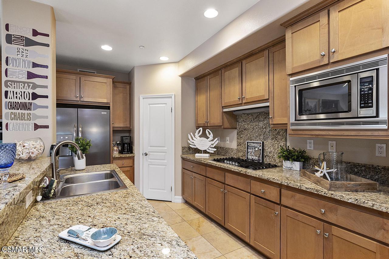 1501 Windshore Way Oxnard, CA 93035 - Photo 4 of 24 a kitchen with stainless steel appliances granite countertop a sink stove microwave refrigerator and cabinets