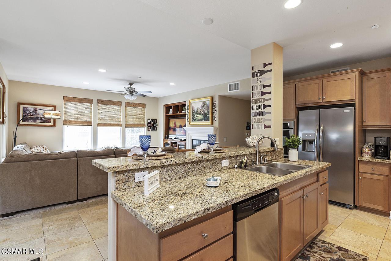 1501 Windshore Way Oxnard, CA 93035 - Photo 7 of 24 a kitchen with stainless steel appliances granite countertop a sink and a refrigerator