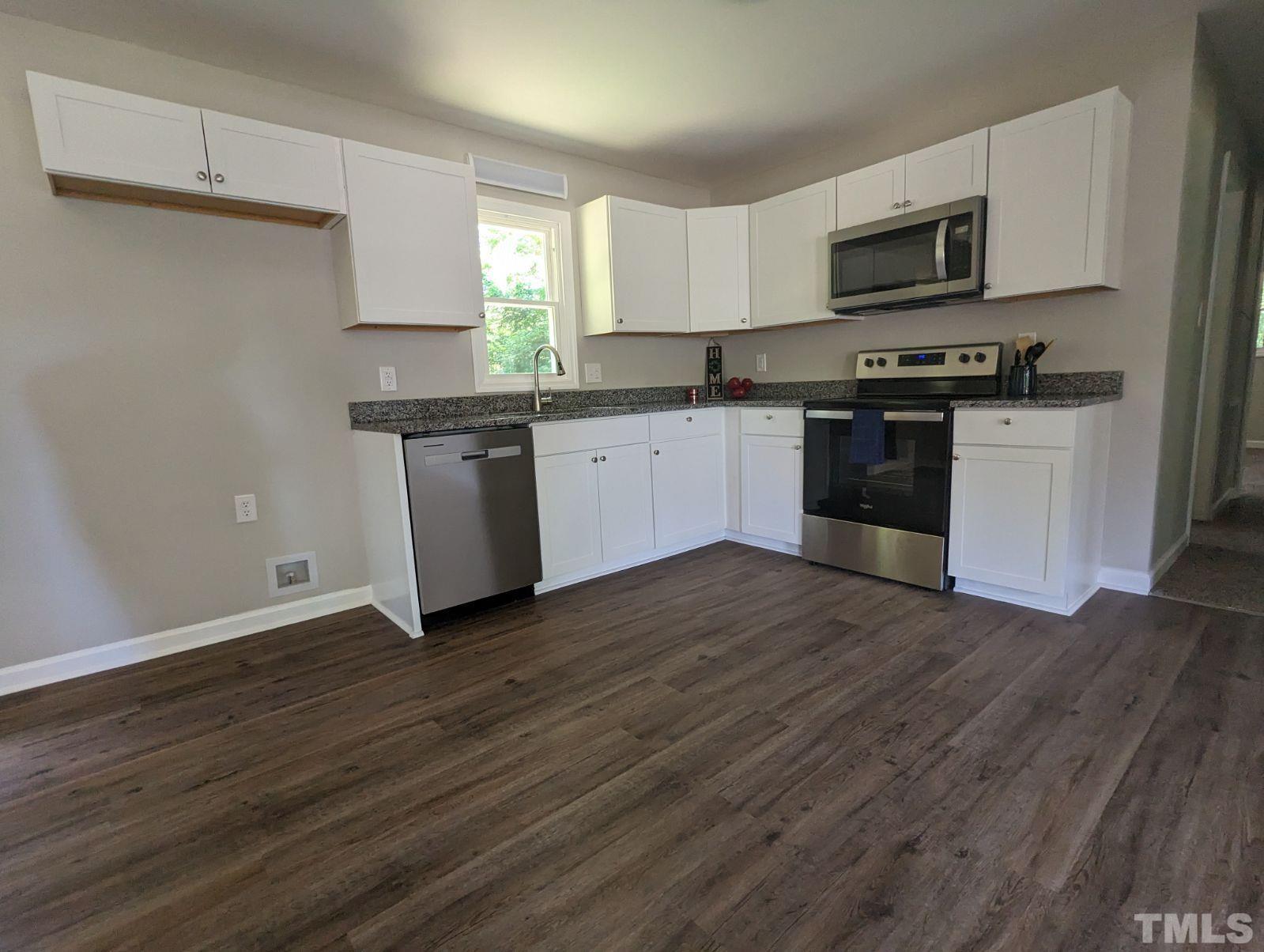 30 Alton Acres Subdivision Road Louisburg, NC 27549 - Photo 12 of 35 a kitchen with granite countertop a refrigerator and a stove top oven