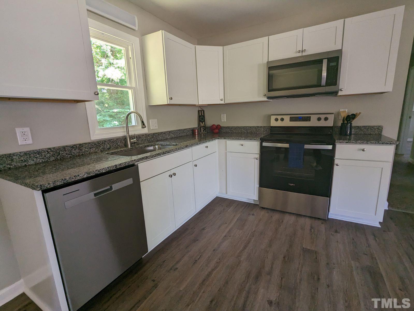30 Alton Acres Subdivision Road Louisburg, NC 27549 - Photo 14 of 35 a kitchen with stainless steel appliances granite countertop a stove a sink and a microwave
