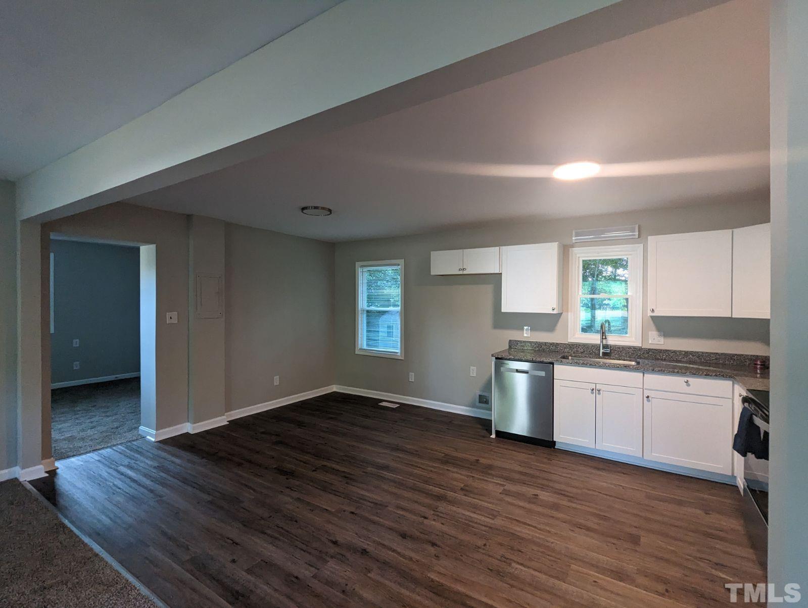 30 Alton Acres Subdivision Road Louisburg, NC 27549 - Photo 15 of 35 a kitchen with granite countertop wooden floors and white stainless steel appliances