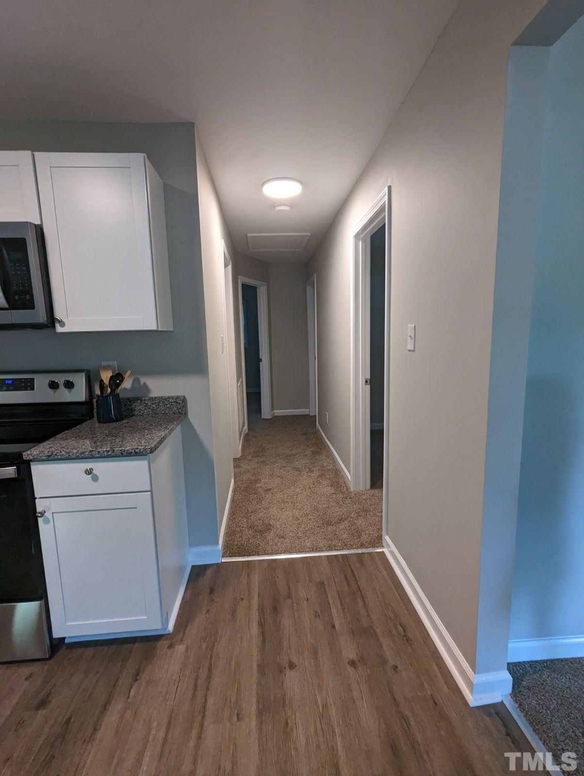 30 Alton Acres Subdivision Road Louisburg, NC 27549 - Photo 21 of 35 a kitchen with wooden floors and white appliances