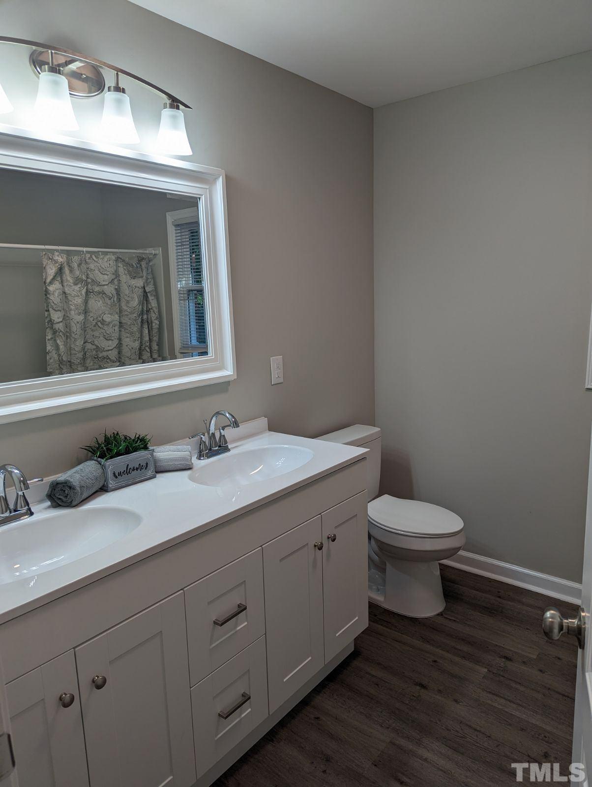 30 Alton Acres Subdivision Road Louisburg, NC 27549 - Photo 25 of 35 a bathroom with a toilet sink and mirror