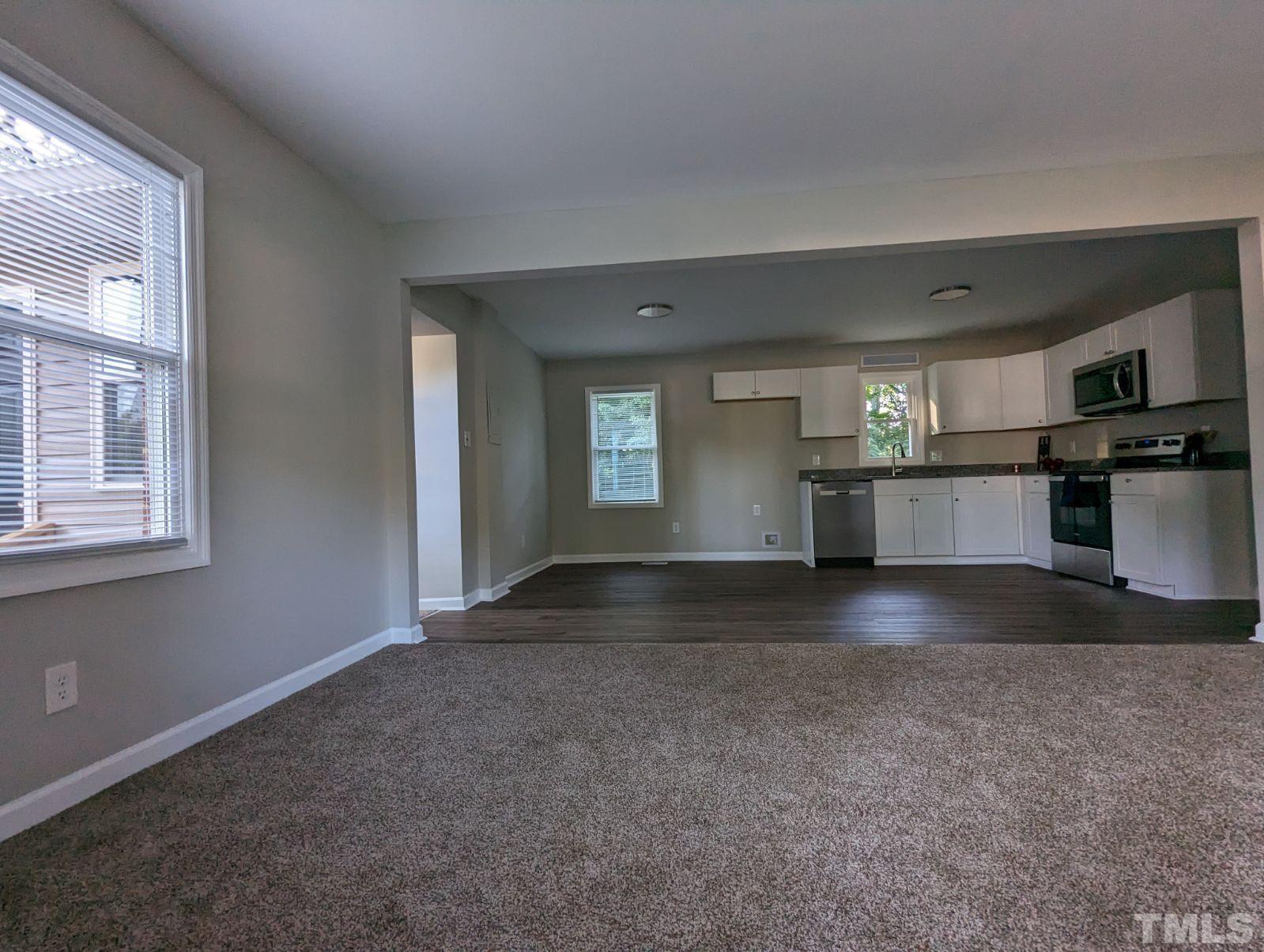 30 Alton Acres Subdivision Road Louisburg, NC 27549 - Photo 9 of 35 an empty room with a kitchen and windows