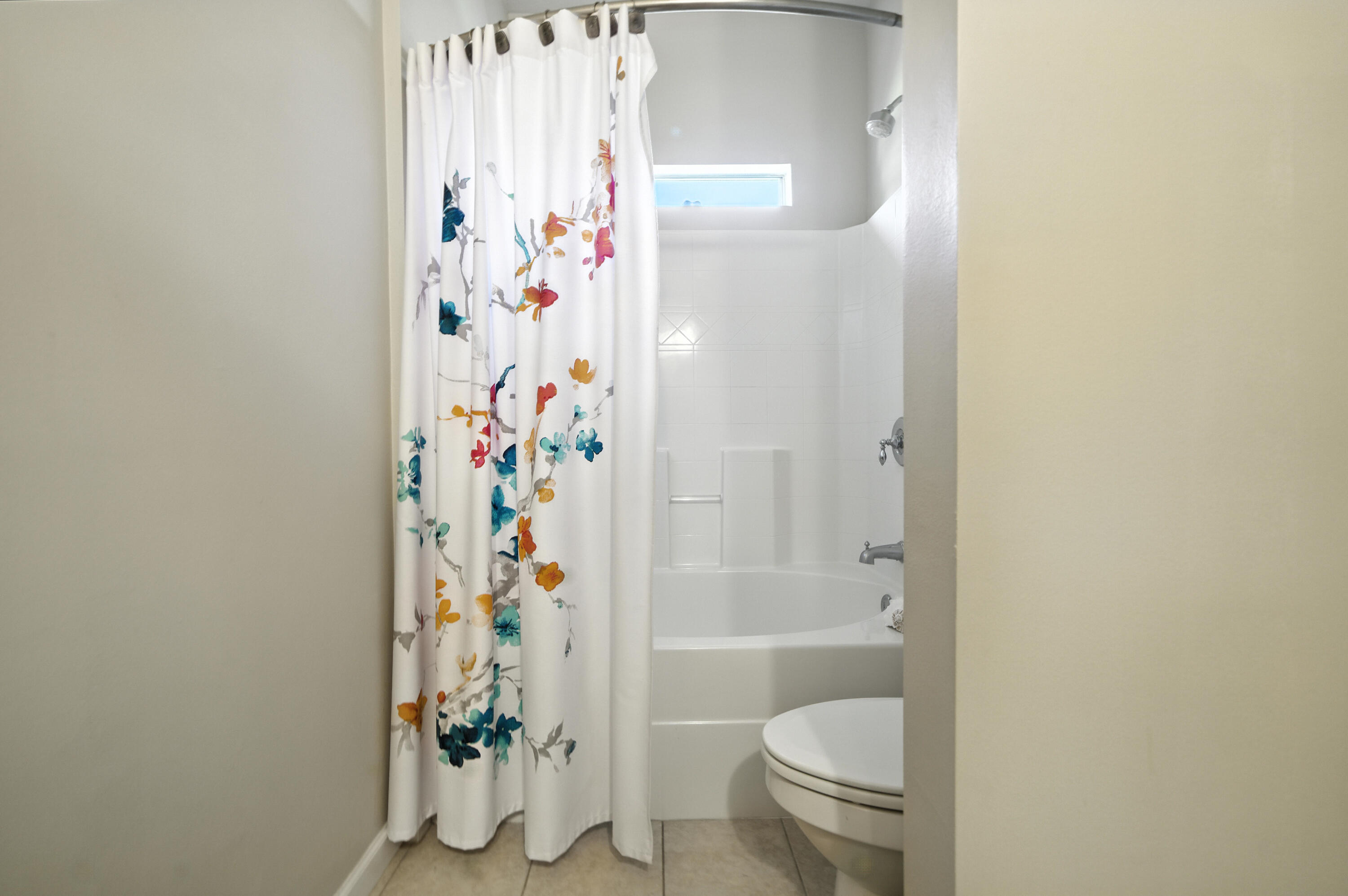 4629 Hermosa Road Crestview, FL 32539 - Photo 16 of 26 a bathroom with a shower curtain and toilet