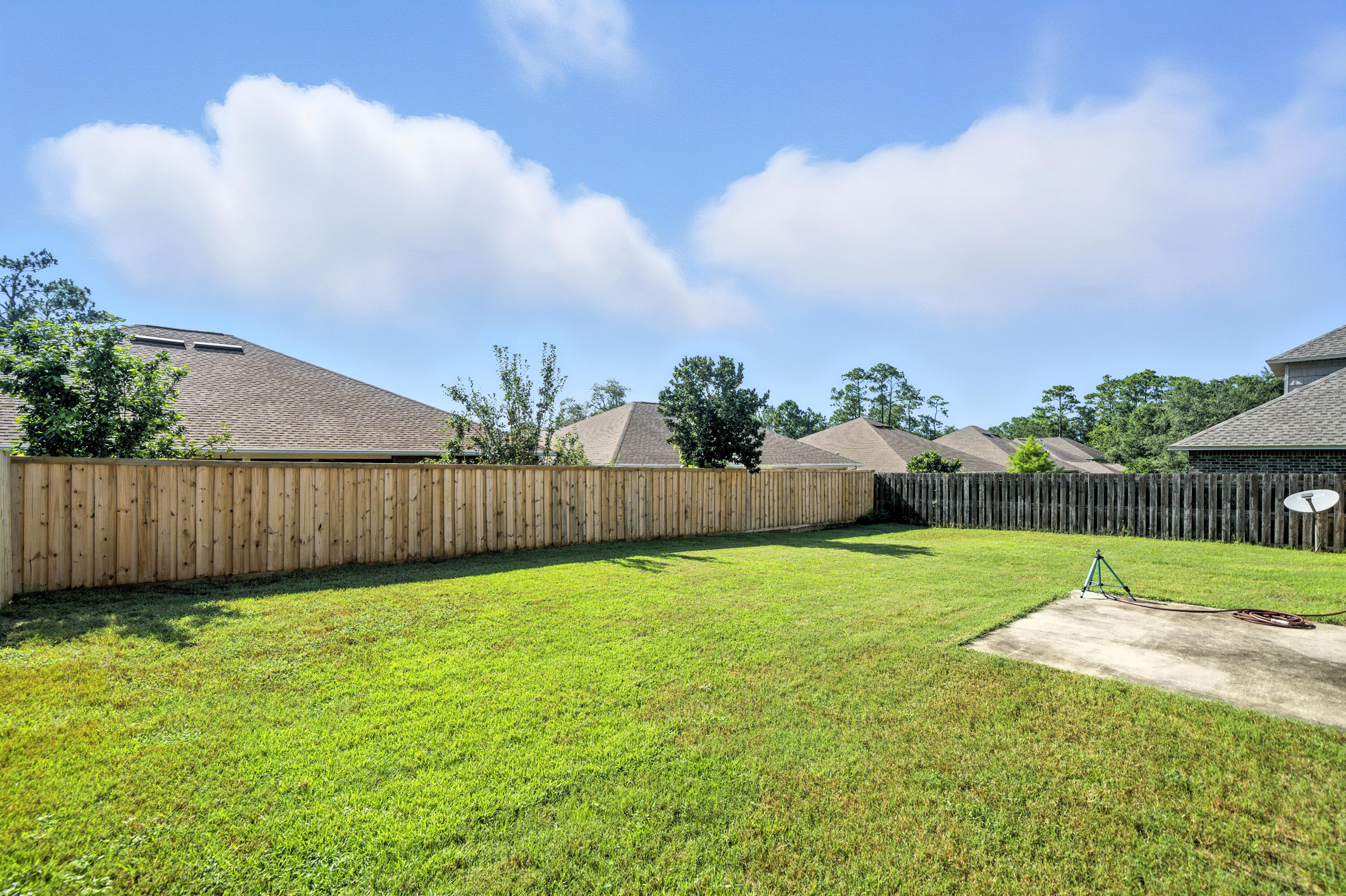 4629 Hermosa Road Crestview, FL 32539 - Photo 23 of 26 a view of a backyard with potted plants and wooden fence