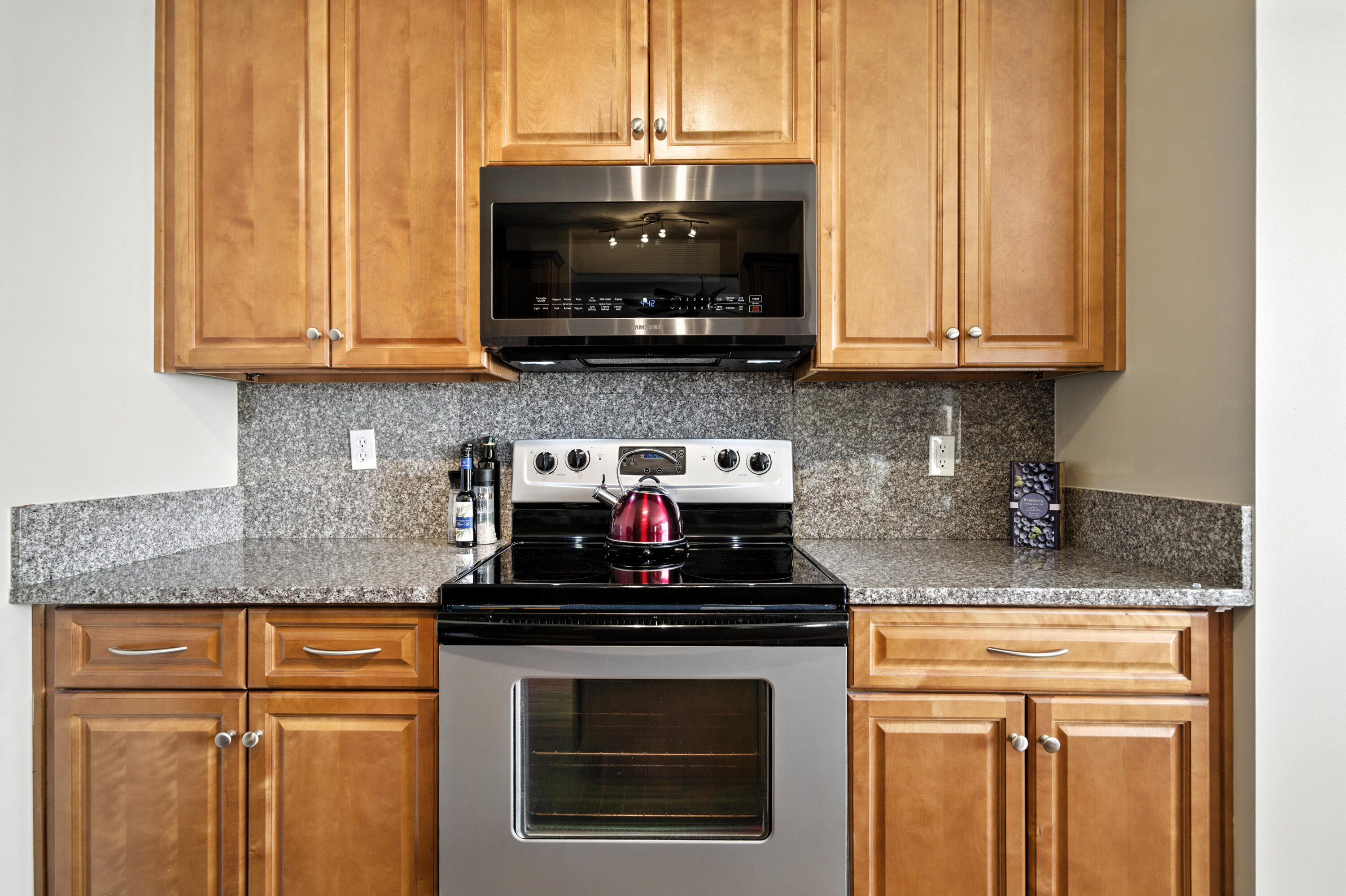 4629 Hermosa Road Crestview, FL 32539 - Photo 7 of 26 a kitchen with stainless steel appliances granite countertop a stove a sink and a microwave