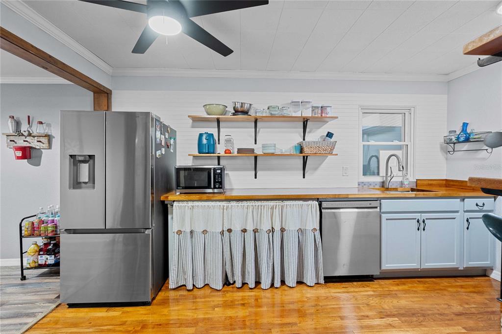 110 County Road 534 Bushnell, FL 33513 - Photo 13 of 60 a kitchen with stainless steel appliances a refrigerator and a sink