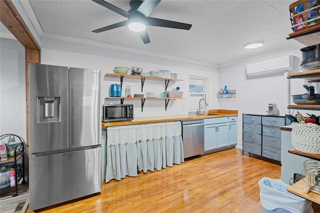110 County Road 534 Bushnell, FL 33513 - Photo 15 of 60 a kitchen with stainless steel appliances a refrigerator and a wooden floor