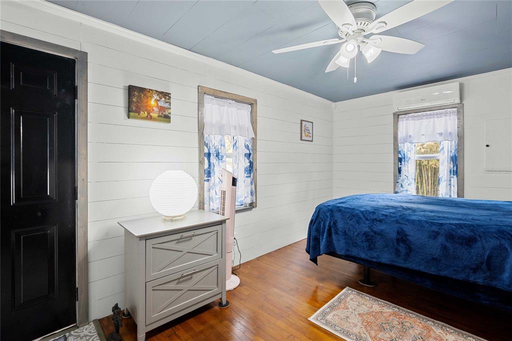 110 County Road 534 Bushnell, FL 33513 - Photo 16 of 60 a bedroom with a bed and a chandelier