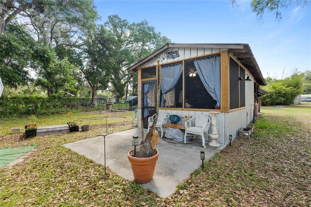 110 County Road 534 Bushnell, FL 33513 - Photo 24 of 60 a view of a house with backyard and sitting area