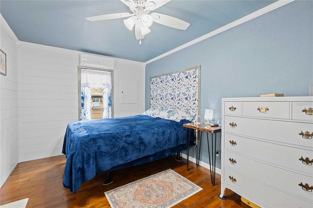 110 County Road 534 Bushnell, FL 33513 - Photo 4 of 60 a bedroom with a bed and a chandelier