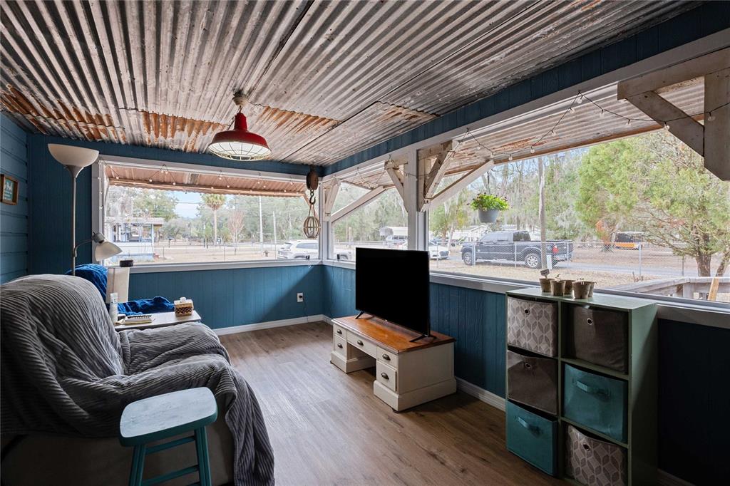 110 County Road 534 Bushnell, FL 33513 - Photo 7 of 60 a living room with furniture a fireplace and a large window