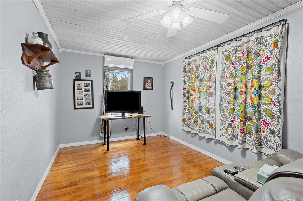 110 County Road 534 Bushnell, FL 33513 - Photo 8 of 60 a living room with furniture and a flat screen tv