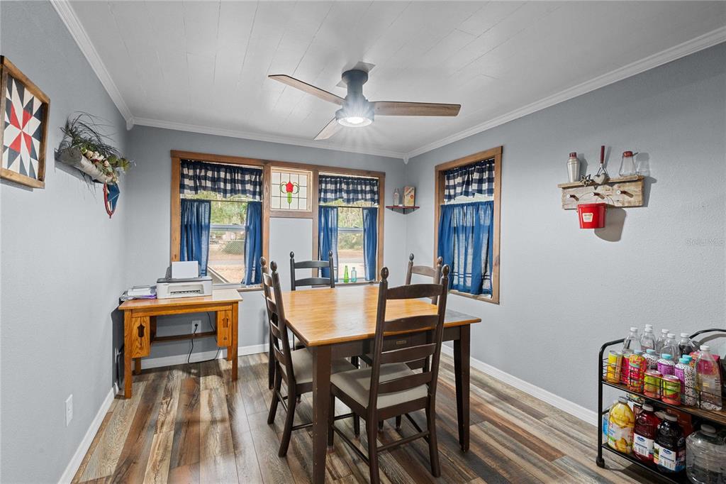 110 County Road 534 Bushnell, FL 33513 - Photo 10 of 60 a view of a dining room with furniture a chandelier and wooden floor