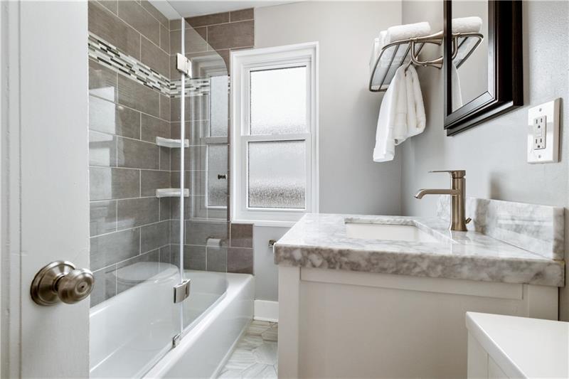 490 Mapleton Avenue Pittsburgh, PA 15228 - Photo 19 of 35 a bathroom with a granite countertop sink a mirror and shower