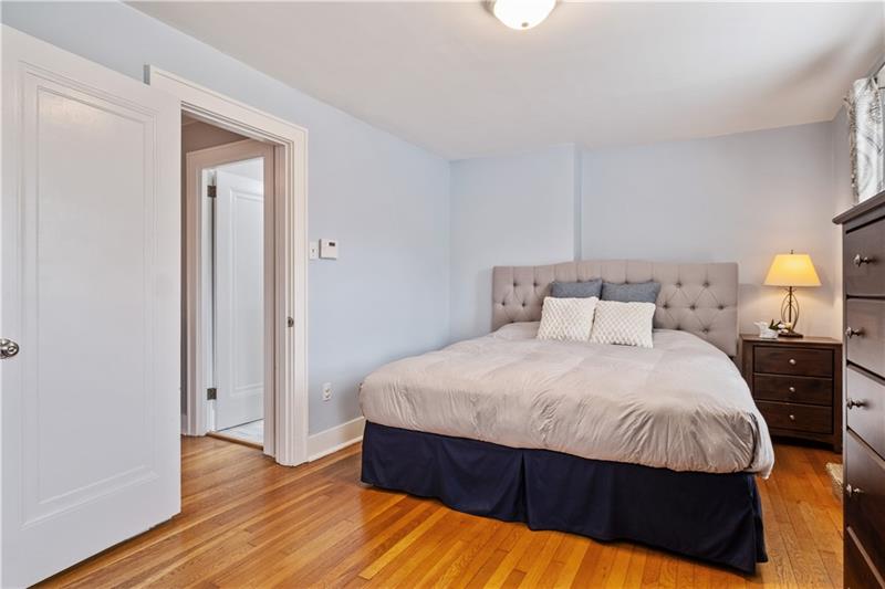 490 Mapleton Avenue Pittsburgh, PA 15228 - Photo 23 of 35 a bedroom with a bed and wooden floor