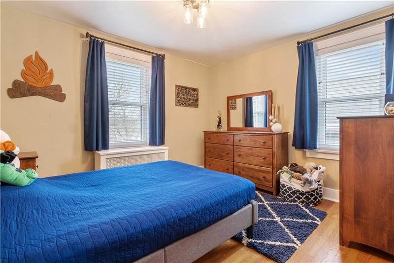 490 Mapleton Avenue Pittsburgh, PA 15228 - Photo 24 of 35 a bedroom with a bed and wooden floor
