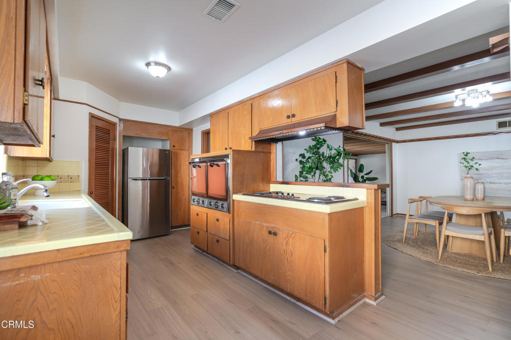 1504 East Grovecenter Street Covina, CA 91724 - Photo 6 of 17 a kitchen with refrigerator and cabinets