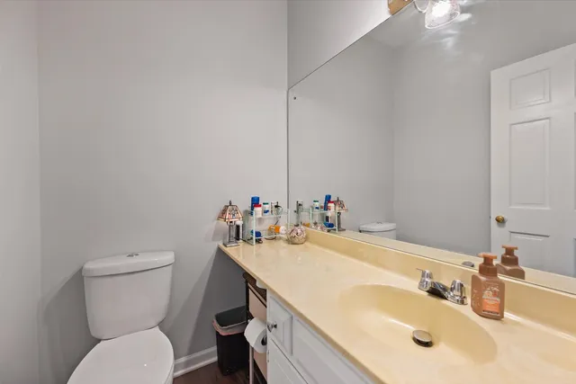 a bathroom with a sink vanity mirror and toilet